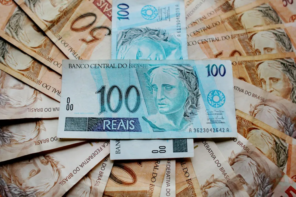 Close-up of Brazilian Real banknotes featuring different denominations and intricate designs.